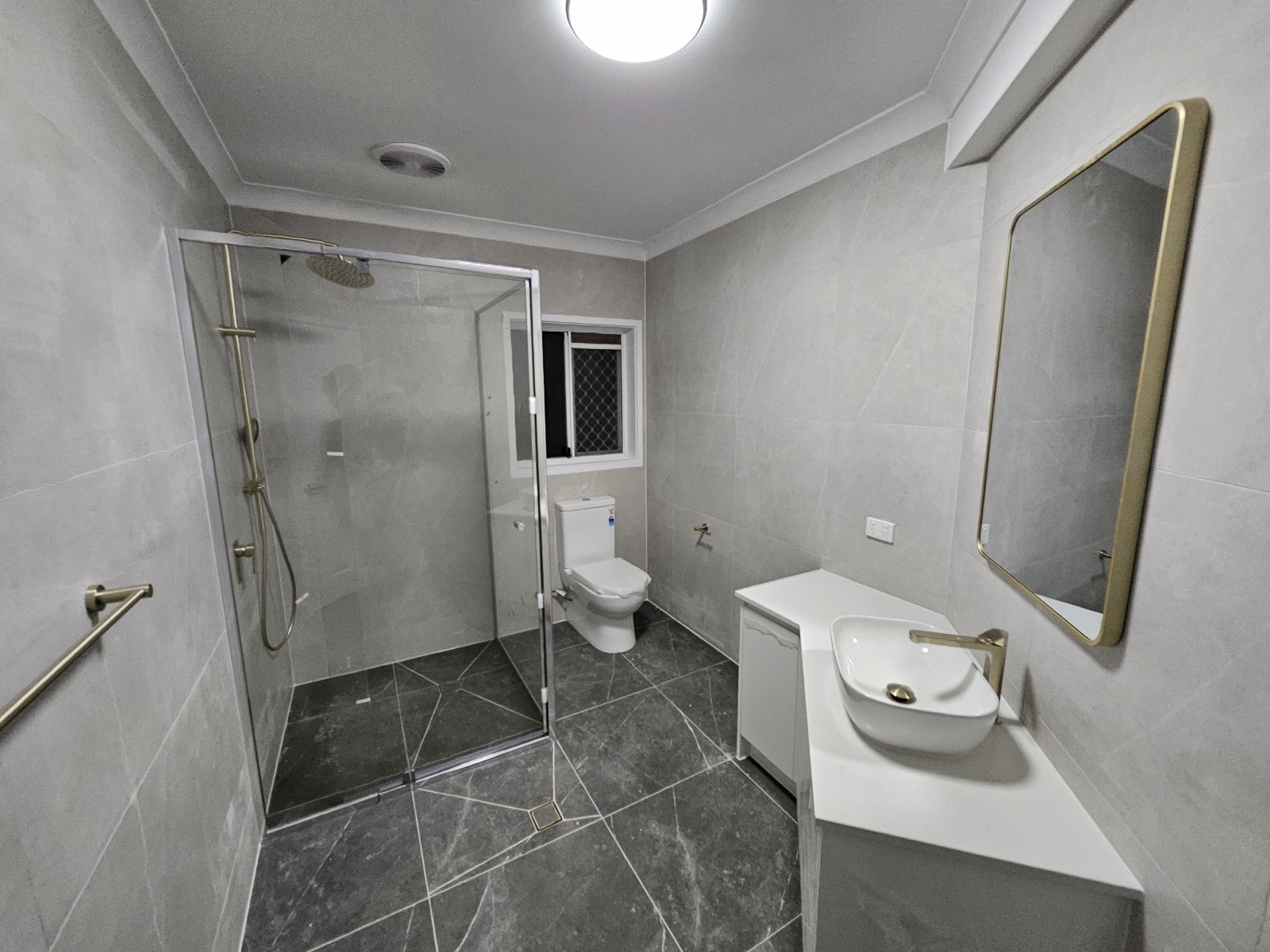Bathroom renovation grey tiles