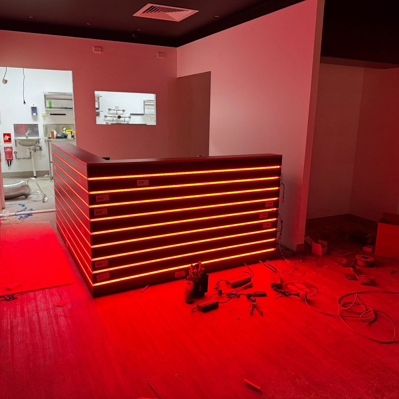 Custom counter joinery with red LED strip lighting